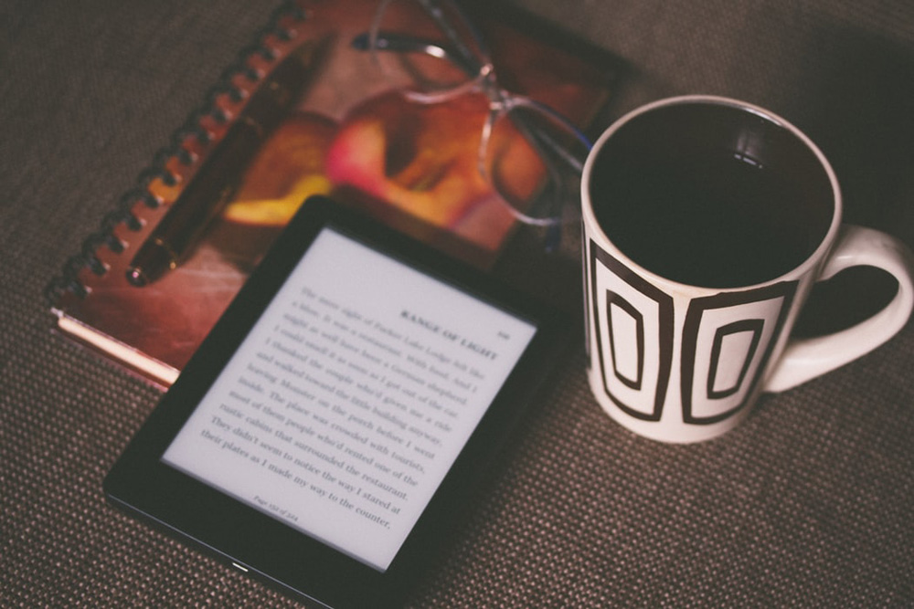 kindle and coffee on a table