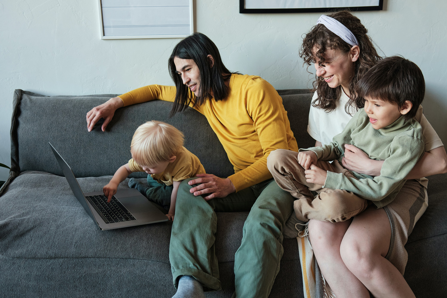man woman and kids sitting on a couch