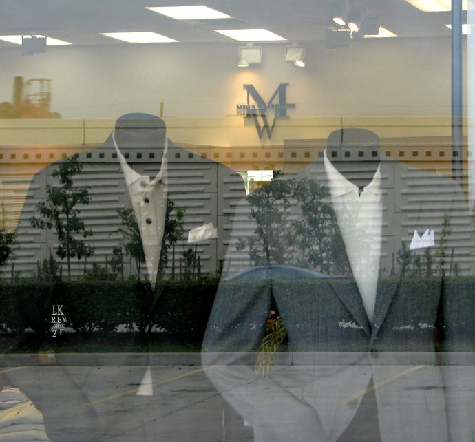 mannequins wearing suits by window of mens wearhouse
