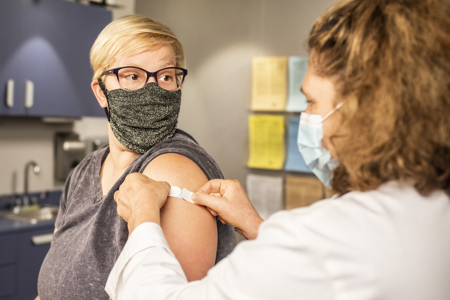 woman getting vaccine from doctor