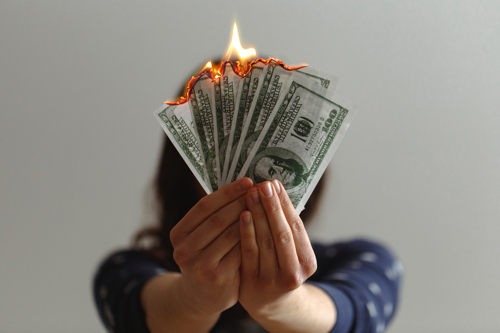 woman holding burning money
