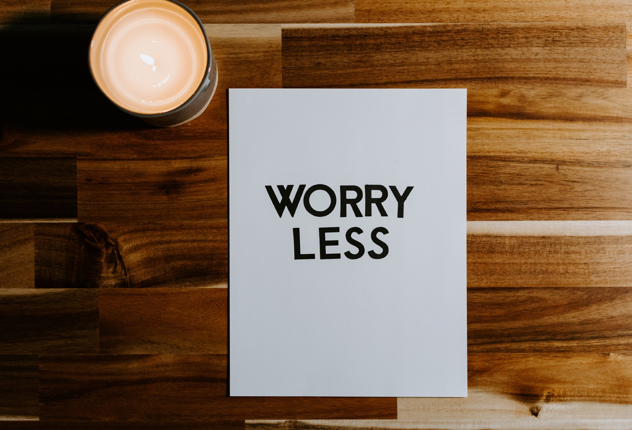 worry less message on paper on a desk